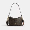 Carey-crossbody-veske i «Loved»-Signature Canvas med anheng