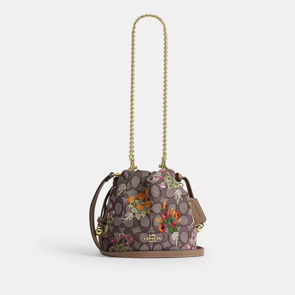 Faye Miniveske i signaturjacquard med blomsterbroderi