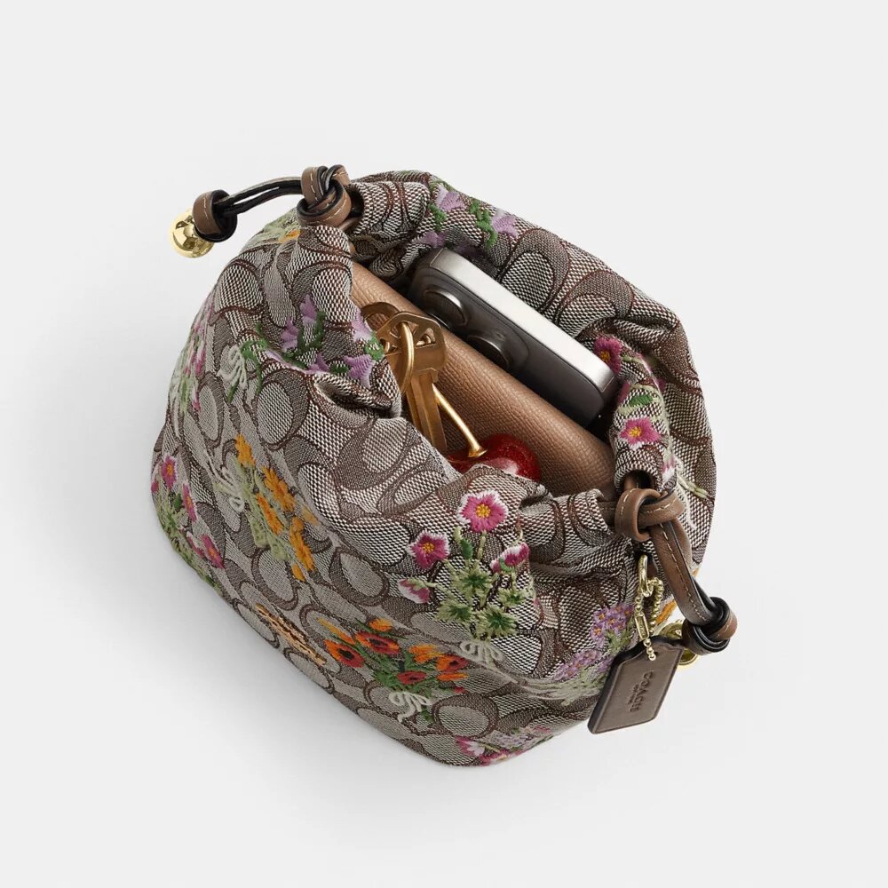 Faye Miniveske i signaturjacquard med blomsterbroderi