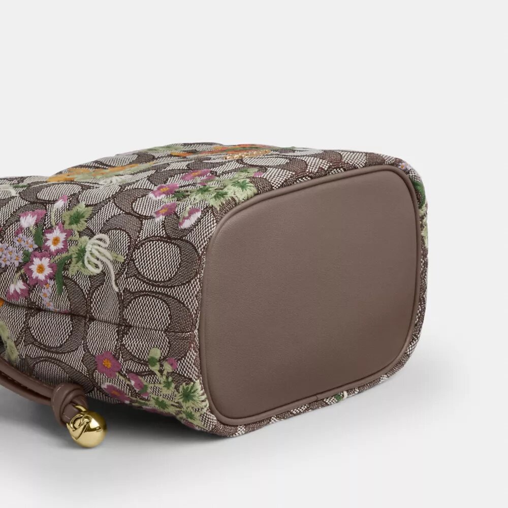 Faye Miniveske i signaturjacquard med blomsterbroderi