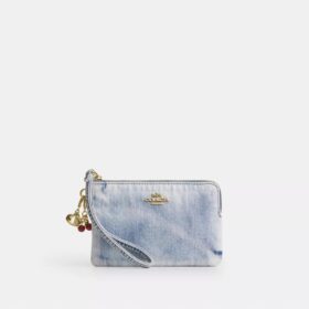 Håndleddsveske med glidelås i hjørnet i «Loved Denim» med anheng