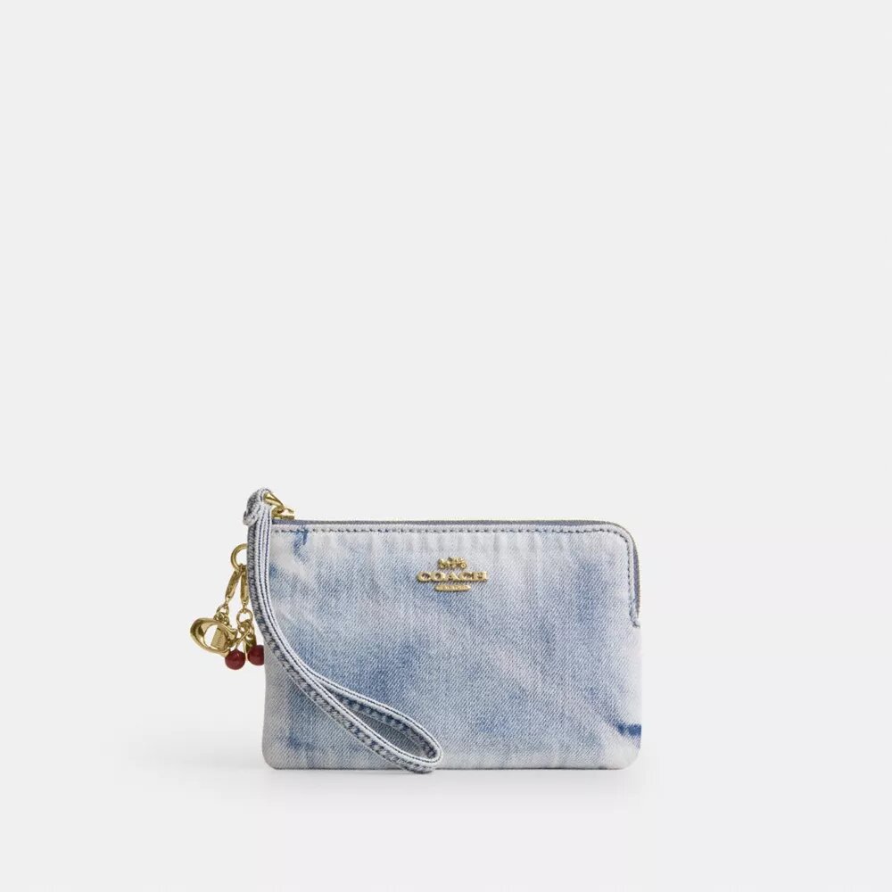 Håndleddsveske med glidelås i hjørnet i «Loved Denim» med anheng