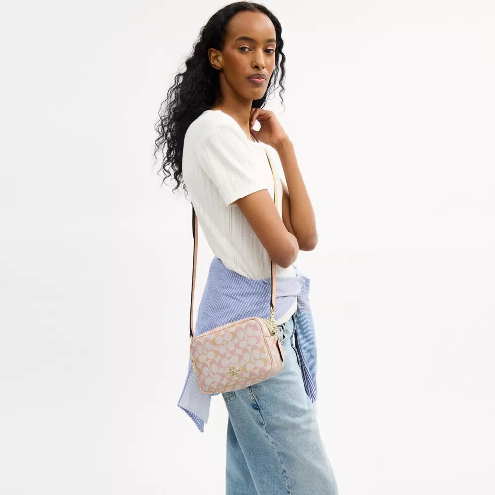 Mini Carey-crossbody-veske i Signature Canvas