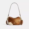 Mini Carey-crossbody-veske med kryssrem i hårkalv med ku-mønster