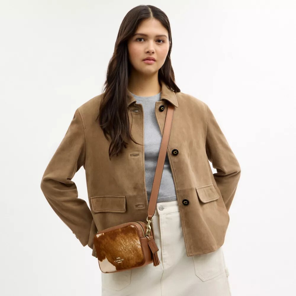 Mini Carey-crossbody-veske med kryssrem i hårkalv med ku-mønster