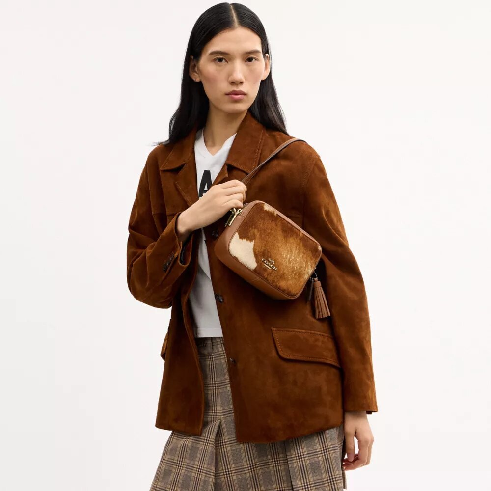 Mini Carey-crossbody-veske med kryssrem i hårkalv med ku-mønster