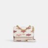 Mini Klare-crossbody-veske med kryssrem og godterimønster