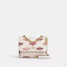 Mini Klare-crossbody-veske med kryssrem og godterimønster