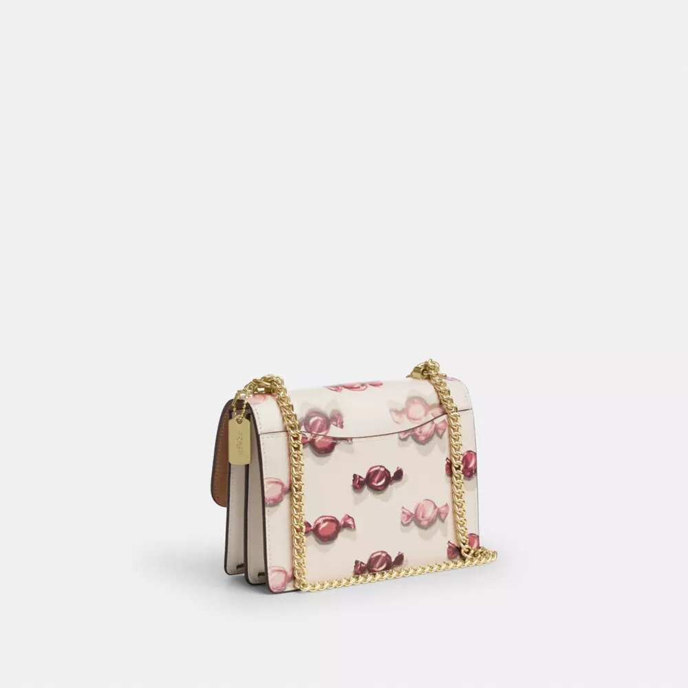 Mini Klare-crossbody-veske med kryssrem og godterimønster