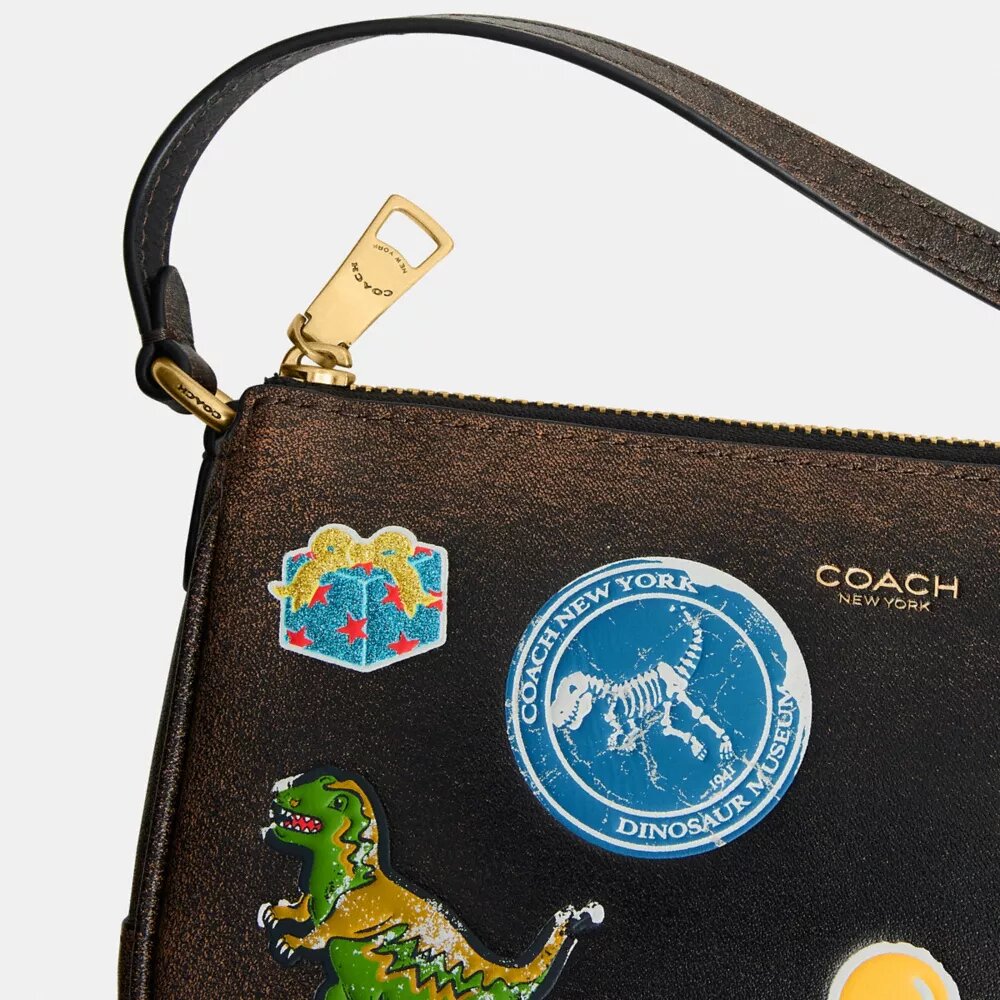 Rexy 10-årsdag Plaza-veske 18 i «Loved Leather» med klistremerketrykk