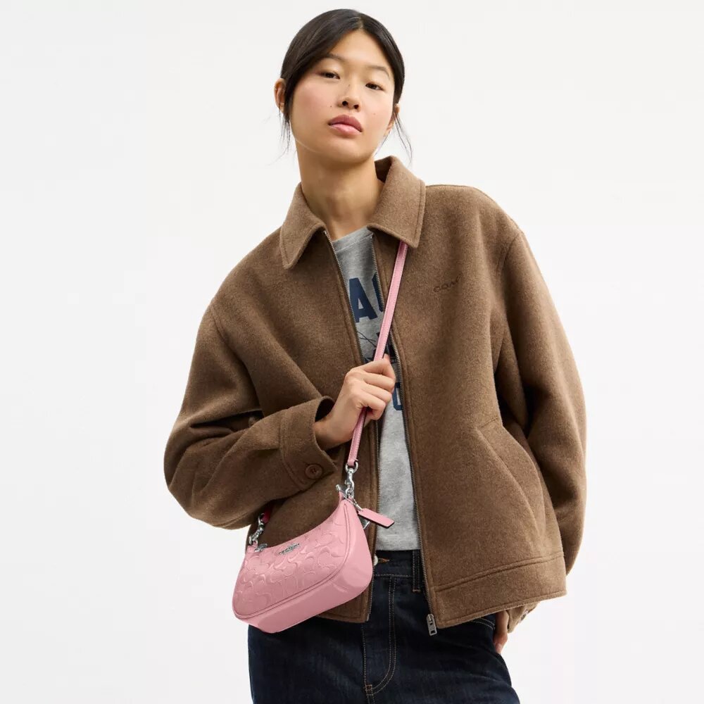 Teri Mini-crossbody-veske i signaturlær med hjerteanheng